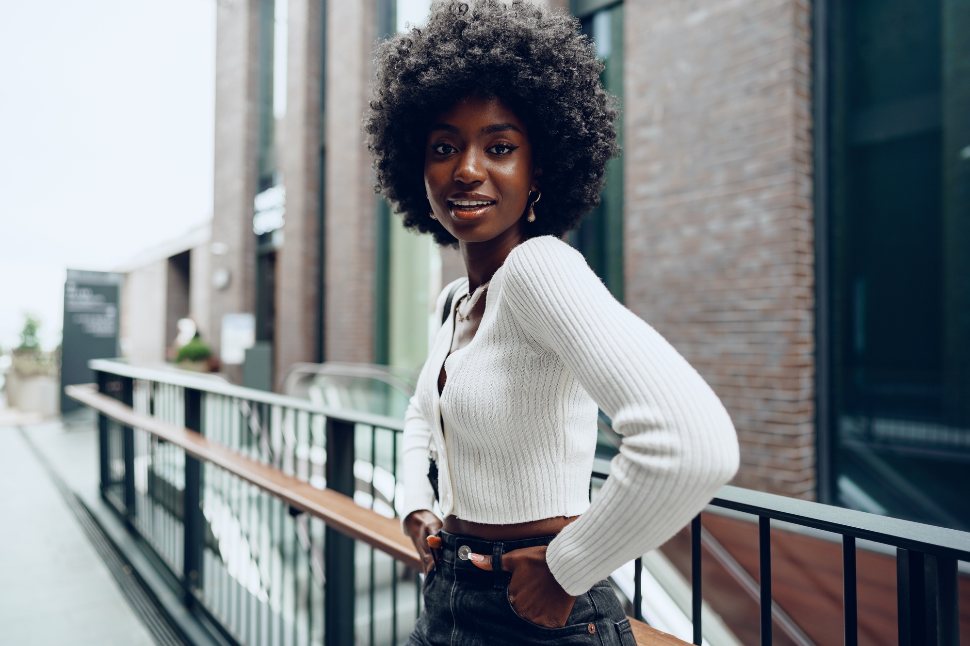 African young woman standing on city street outdoors